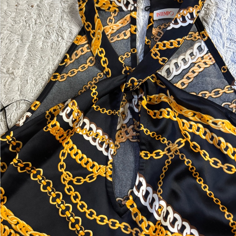 Silky satin designer style women’s top. Black with gold and white chain design.